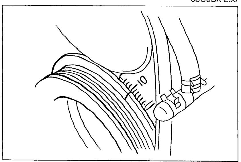 Engine view showing the crankshaft pulley area with the yellow timing mark aligned to the timing belt lower cover mark.