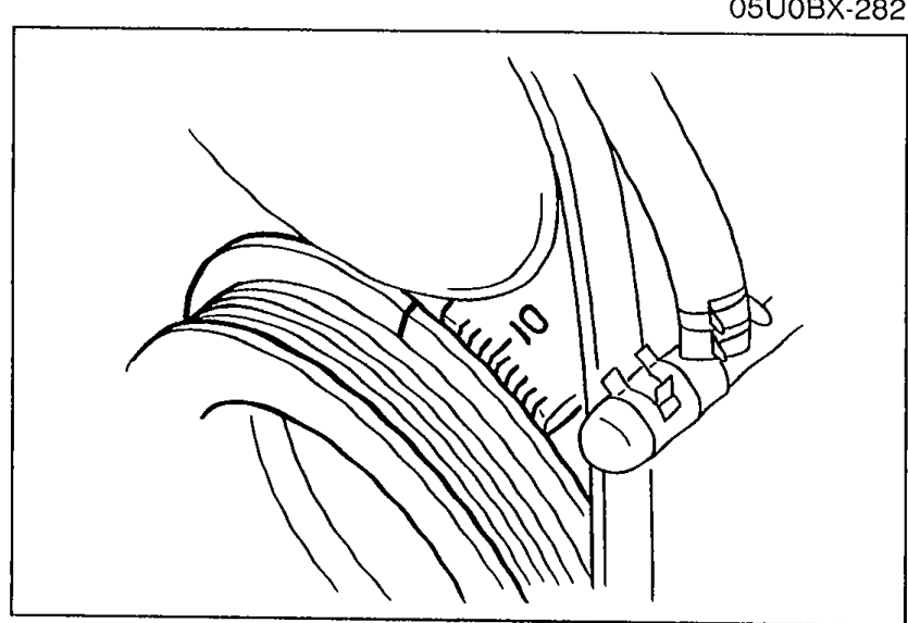 Crankshaft pulley close-up showing the timing marks used to verify ignition timing advance with engine speed increase.
