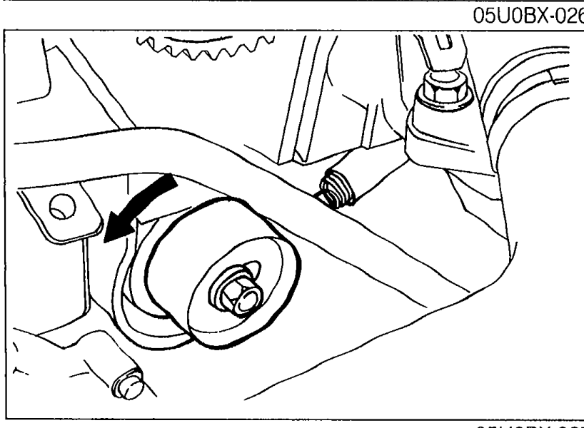Tensioner being installed with the tensioner spring; arrow indicates direction to rotate to extend the spring.