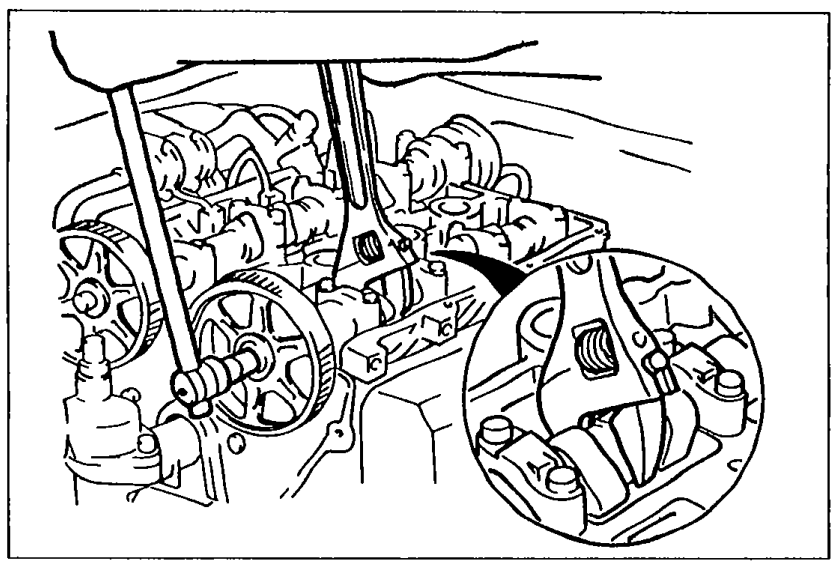 View of camshaft pulley with wrench holding the camshaft while pulley lock bolt is removed.