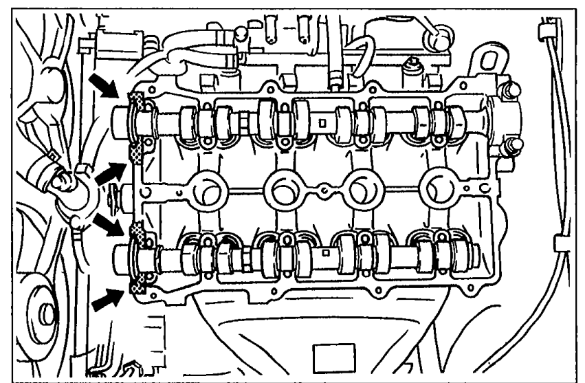Top view of cylinder head showing arrows where silicone sealant is to be applied to shaded camshaft cap mating areas.