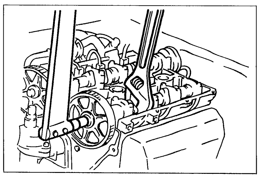 View of cylinder head end with wrench holding the camshaft while camshaft pulley lock bolt is tightened.