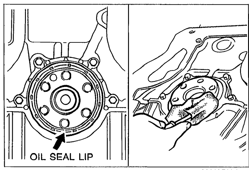 Cutting the rear oil seal lip with a razor knife. Arrow labeled OIL SEAL LIP points to the seal on the rear of the crankshaft.