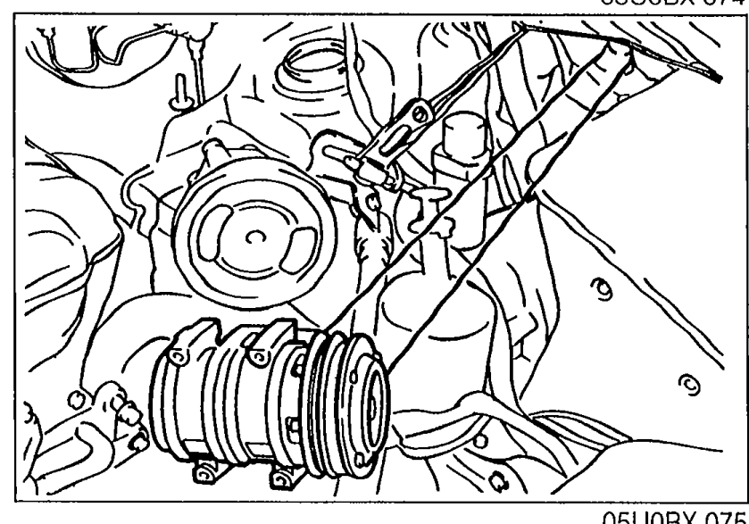 A/C compressor photo showing the compressor mounted with its drive belt, hoses still connected.