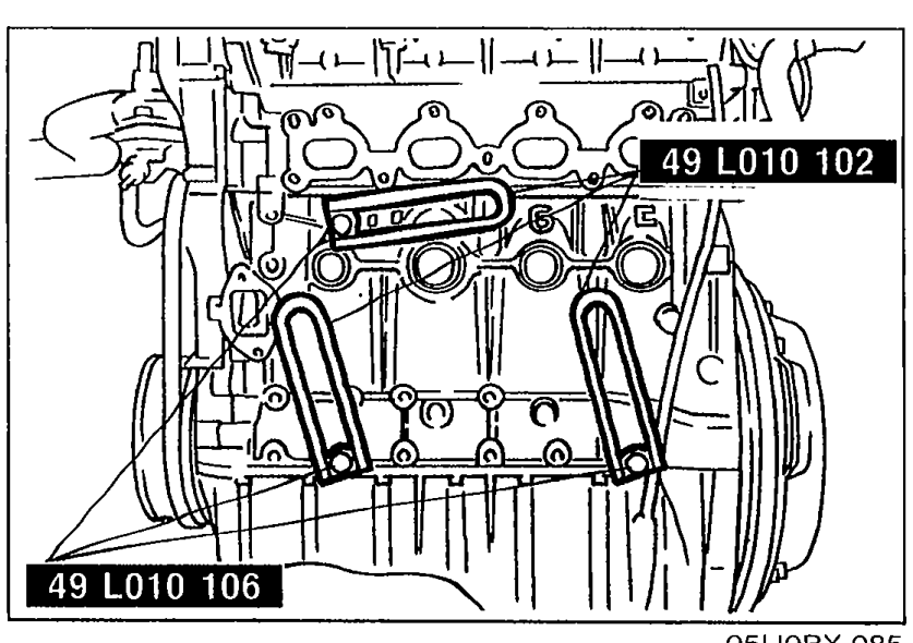 Top view of cylinder head showing the SST arms (49 L010 102 and 49 L010 106) installed in the engine mounting holes.