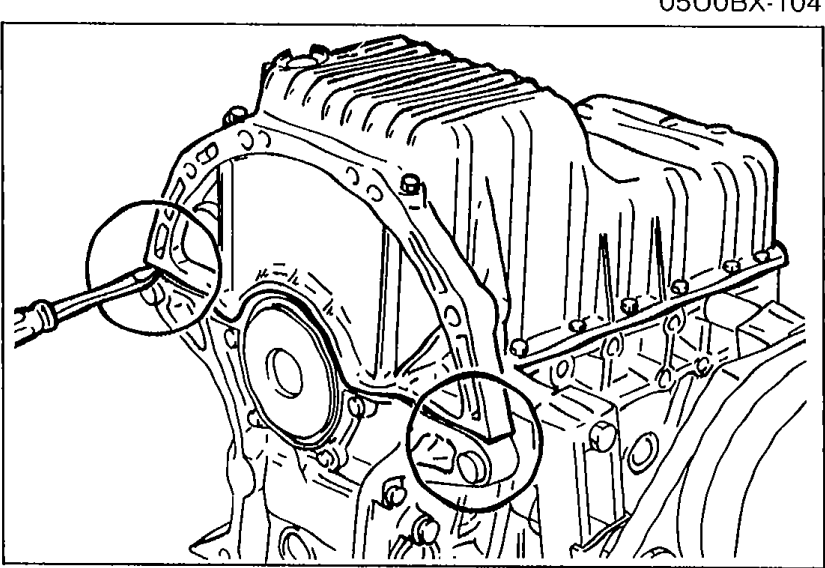 Oil pan removal — engine block inverted with a screwdriver/prying tool inserted at one of the indicated points between the cylinder block and the oil pan to break the sealant bond.