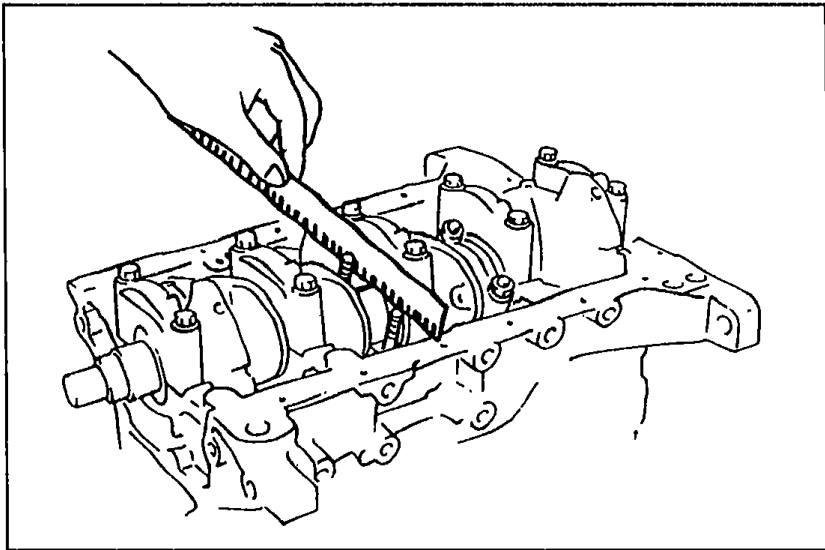 Measuring connecting rod oil clearance with Plastigage on the crankpin journal inside the cylinder block.