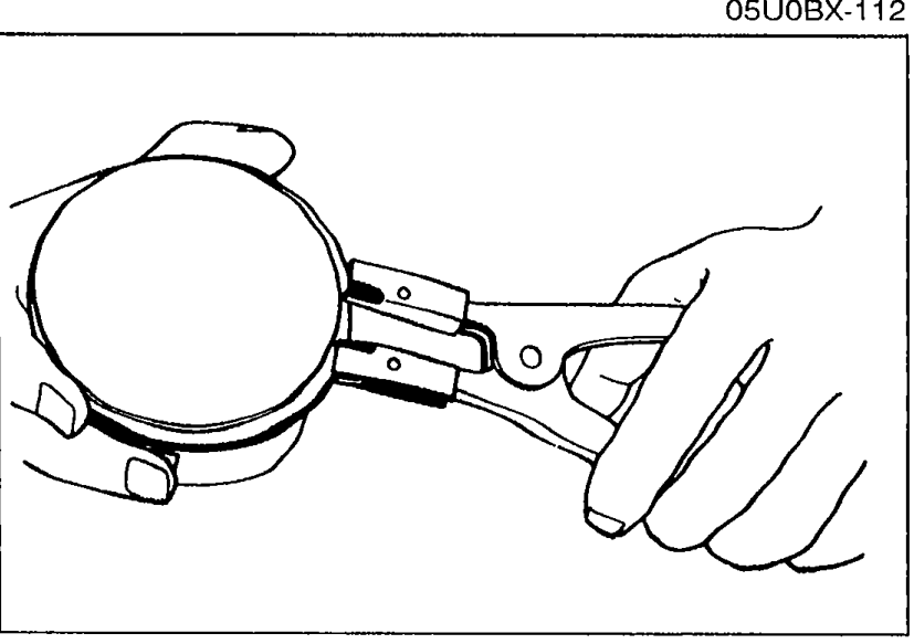 Removing piston rings with a piston ring expander pliers.