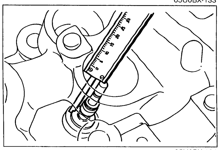 Measuring valve seat sinking with a depth gauge / dial indicator placed over the valve stem at the top of the cylinder head.