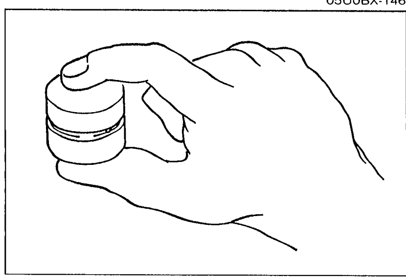 Hand holding an HLA (Hydraulic Lash Adjuster), with thumb pressing the plunger to check movement.