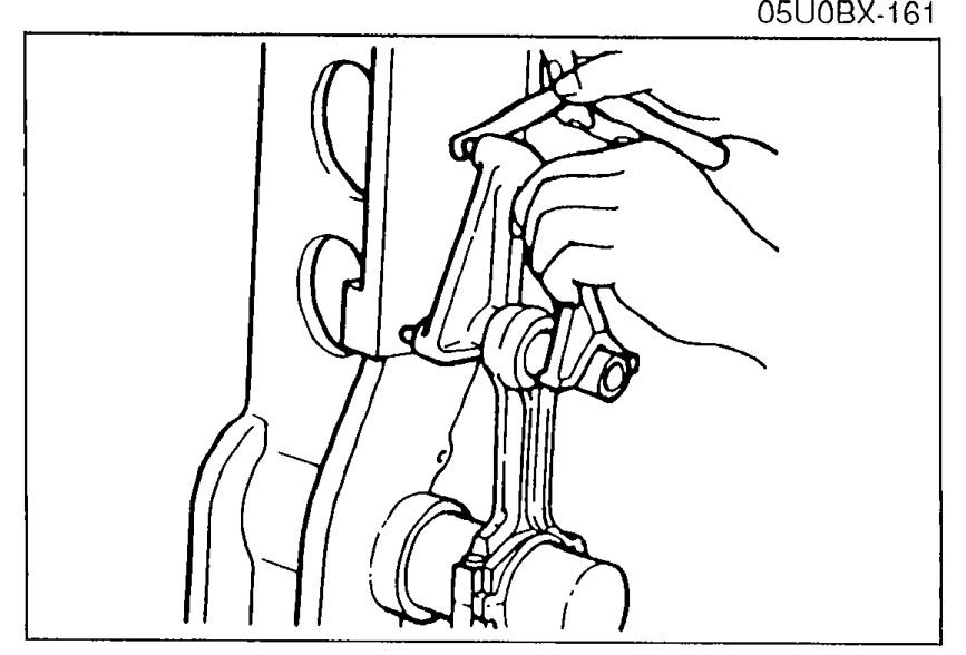 Connecting rod mounted in an alignment fixture / press for bending measurement, with hand operating the gauge.