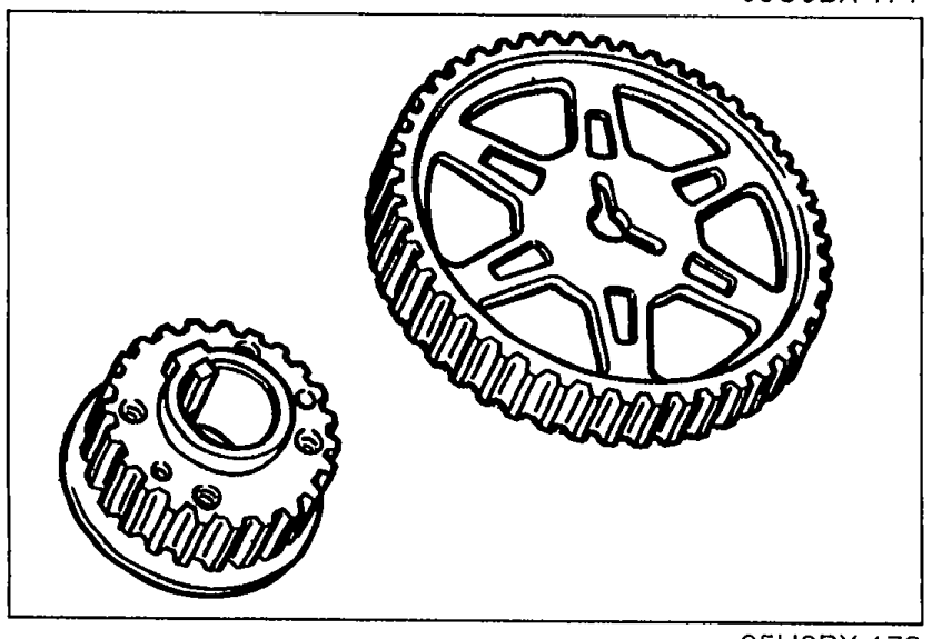 Camshaft pulley (large toothed pulley) and timing belt pulley (smaller toothed pulley) shown together for inspection of teeth wear and deformation.