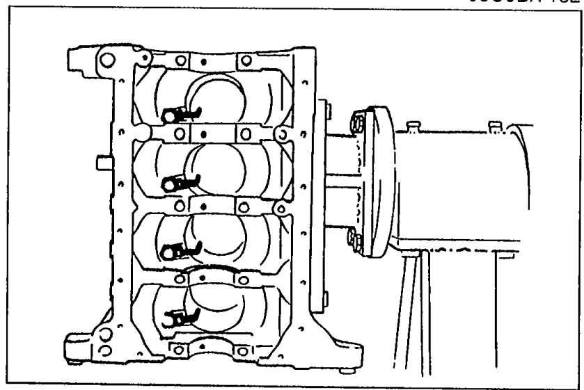 Cylinder block side view with oil jets being installed at the bottom of each cylinder bore.