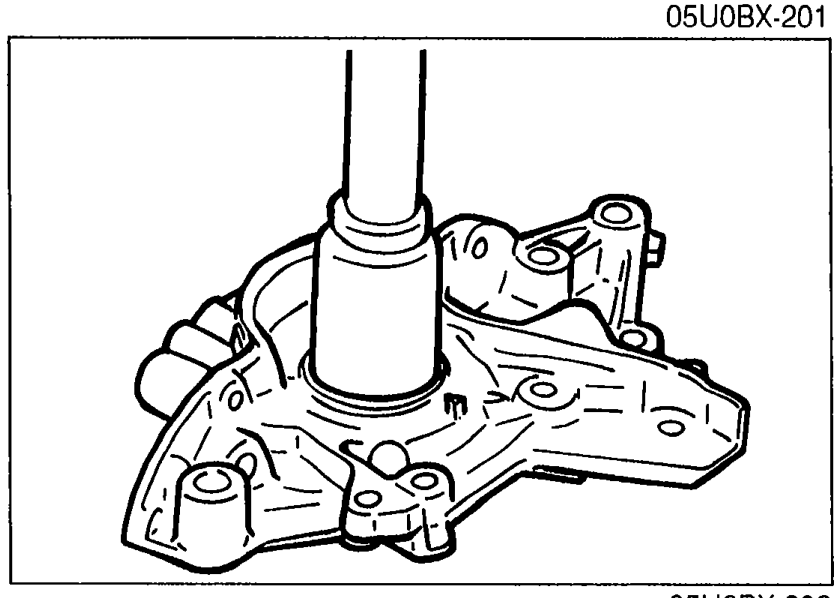 Pressing a new oil seal into the oil pump body using a suitable pipe-shaped driver tool.