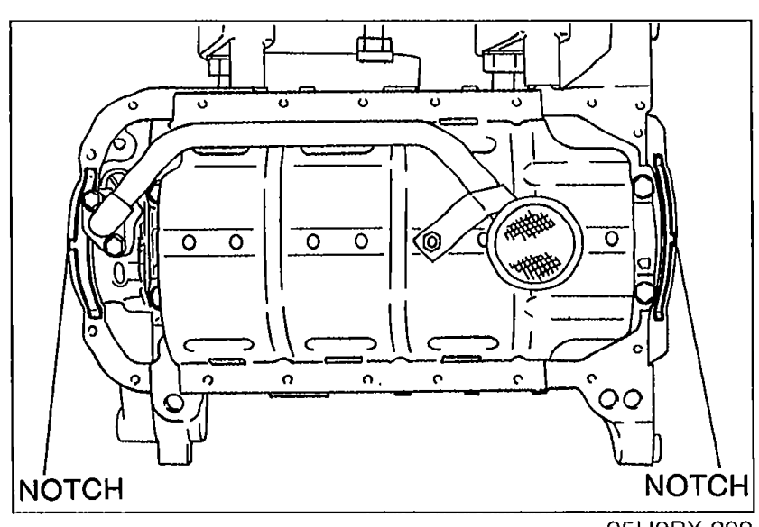 Cylinder block bottom view showing new gaskets installed on the oil pump body and rear cover with 'NOTCH' callouts on both lower corners indicating the projection alignment locations.
