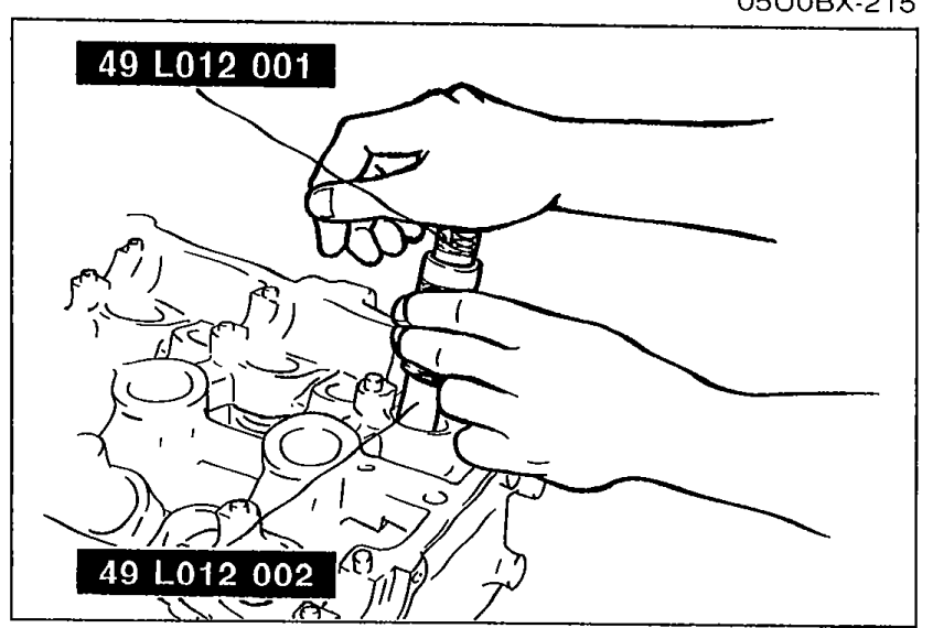 Pressing the valve seal in with the SST until it contacts the cylinder head. SST parts 49 L012 001 (handle) and 49 L012 002 (body) are labeled.