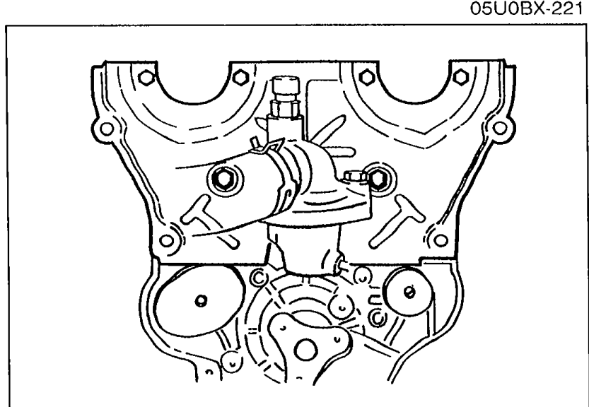 Seal plate installed on the cylinder head front, covering the camshaft drive area with mounting bolts visible around the perimeter.