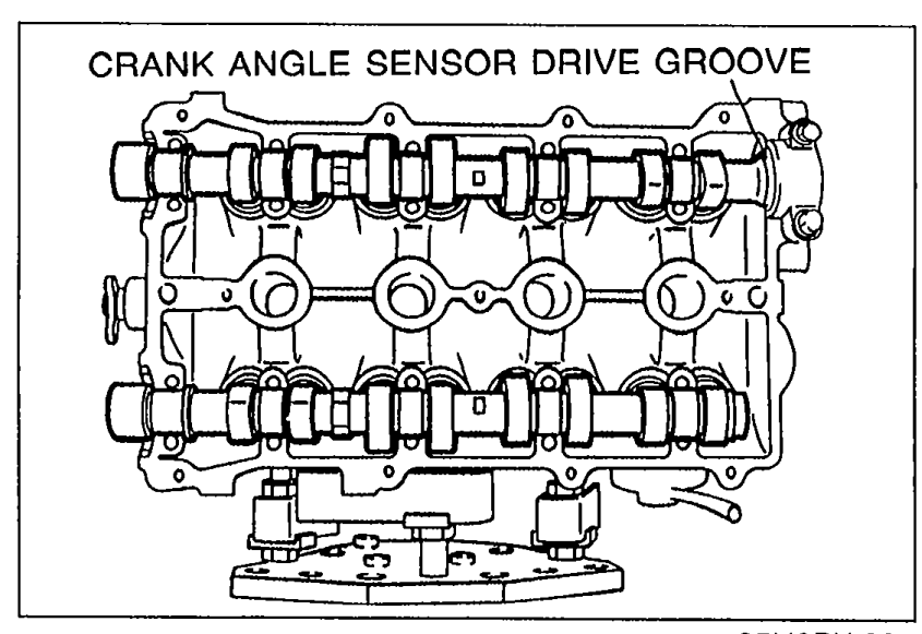 Cylinder head top view showing the intake and exhaust camshafts installed in position. 'CRANK ANGLE SENSOR DRIVE GROOVE' callout points to a groove on the rear of the intake camshaft.