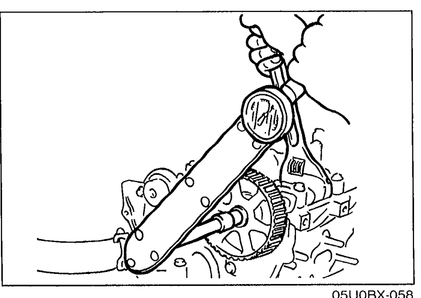 Small illustration at top-left showing a wrench being used to hold the camshaft pulley while tightening the lock bolt. Belt is shown wrapped around the pulley.