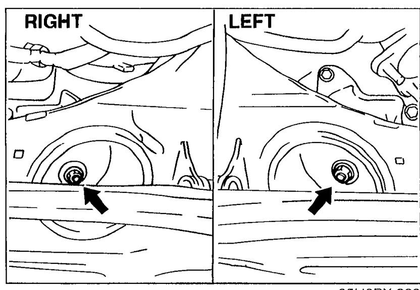 Split-pane underbody view of the engine mount locations labelled 'RIGHT' (left half) and 'LEFT' (right half). Arrows in each pane point to the engine mount nut location.
