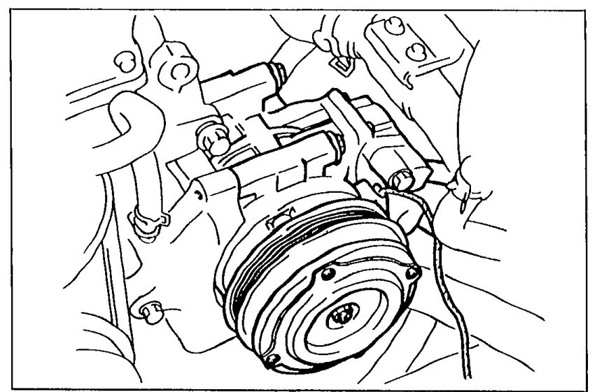 Close-up of the A/C compressor mounted on the front of the engine, showing the compressor pulley and mounting bracket.