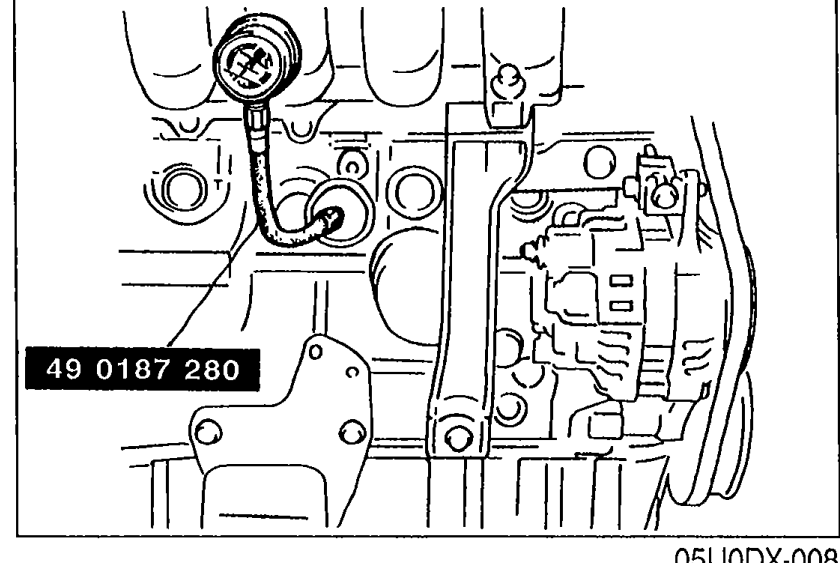 Photograph of the SST 49 0187 280 (label visible) screwed into the oil pressure gauge sender unit installation hole on the engine block.