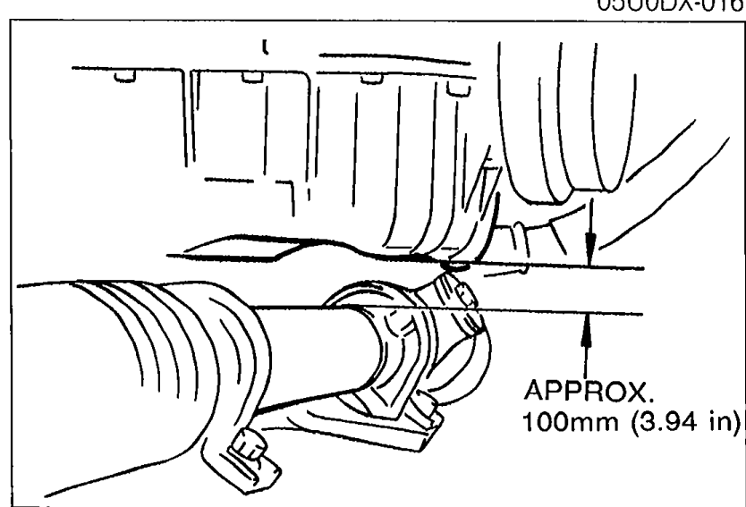 Photograph showing the crossmember lowered relative to the steering intermediate shaft, with a vertical dimension marker reading 'APPROX. 100mm (3.94 in)'.