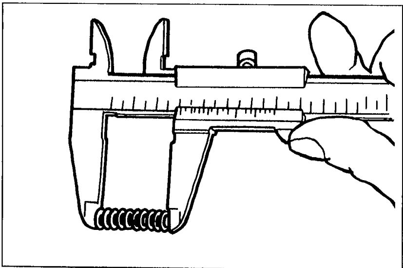 Photograph of vernier calipers measuring the free length of the pressure spring.
