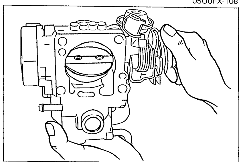 Hand holding throttle body, opening throttle valve to verify it moves smoothly from fully closed to fully open.