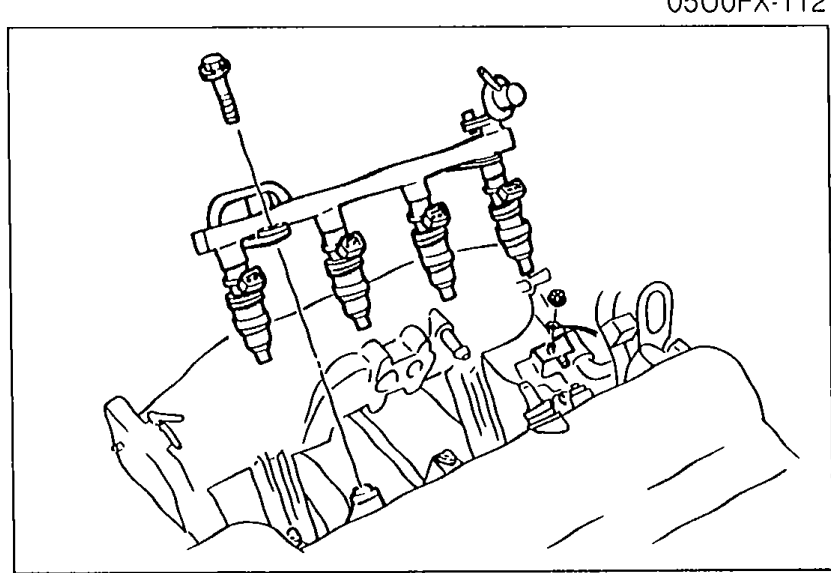 Photo of the intake manifold delivery pipe and injectors mounted on the manifold, prior to removal.