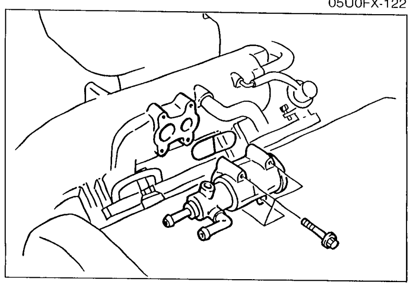 Engine bay photograph showing the air valve mounted on the intake manifold with water hoses attached, illustrating the removal location.