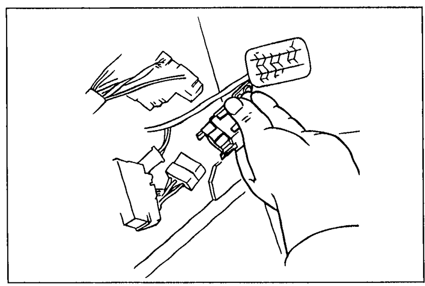 Hand disconnecting the circuit opening relay connector inside the engine bay during fuel pressure release procedure.