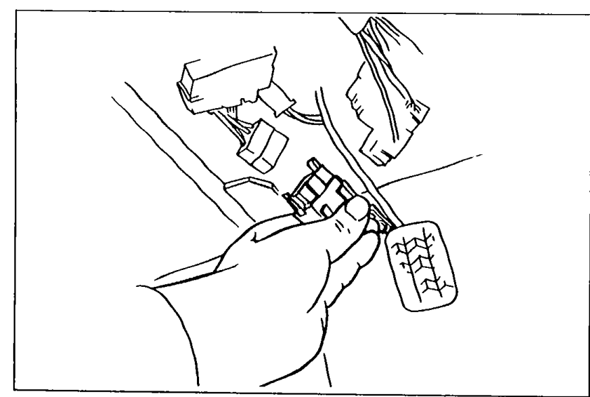 Hand reaching into the engine bay to disconnect a connector — illustrating disconnecting the negative battery terminal as a precaution.