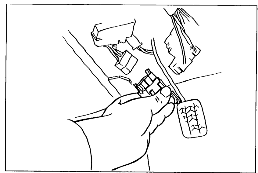Hand disconnecting the negative battery terminal in the engine bay as the first step of the fuel line pressure inspection.