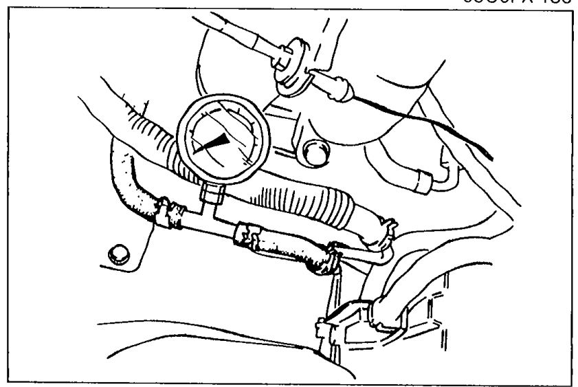 Fuel pressure gauge installed between the fuel pipe and the fuel main hose using hose clamps for fuel line pressure measurement.