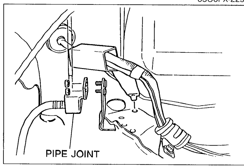 Underside photograph showing the brake pipe joint with a callout 'PIPE JOINT' identifying the joint to be removed with the brake pipe and hose still connected.
