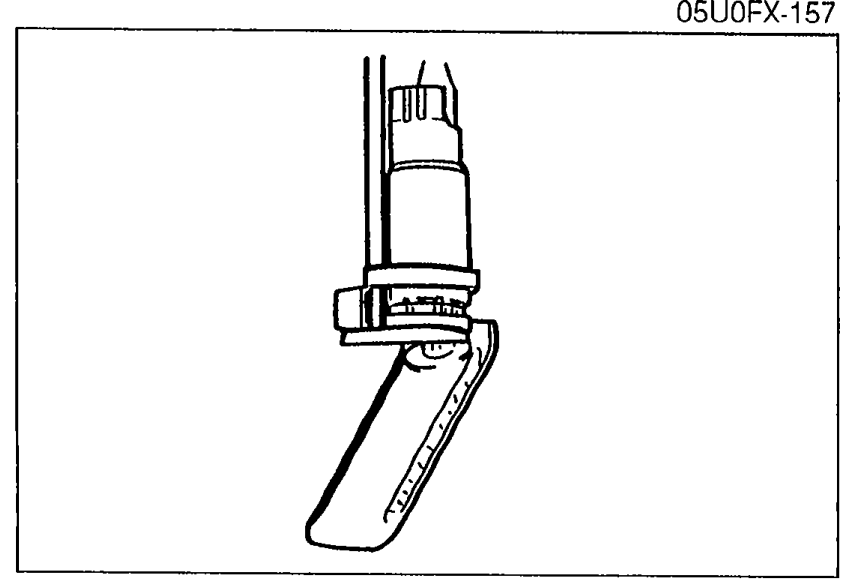 Photo of the fuel pump installed in its mounting bracket, illustrating that the pump must be pulled down tight against the bracket during installation.
