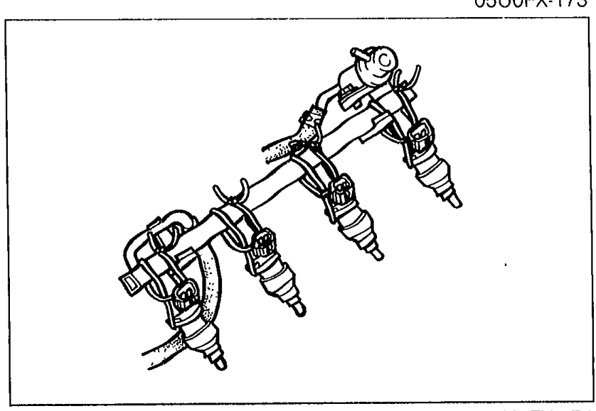 Photo of the delivery pipe with injectors removed from the head, affixed to the delivery pipe with wire and with fuel hoses still connected, prepared for the fuel leakage test.