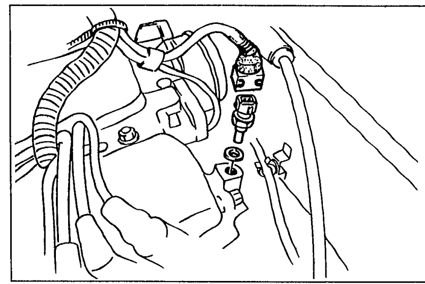 Photo of water thermosensor area at the cylinder head / thermostat housing with the ignition coil region visible; shows the thermosensor connector being accessed for removal.