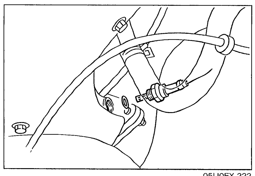 Photo of the oxygen sensor installed in the exhaust manifold area with its electrical connector visible.