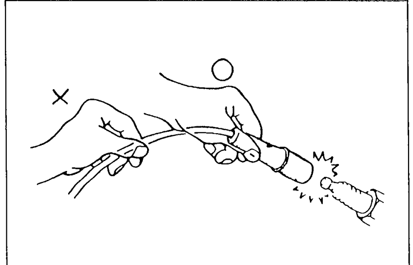Illustration demonstrating correct removal of a high-tension lead: pull on the boot (right hand), not the wire (left hand shown with X). Left X-mark shows incorrect grip on the lead itself.