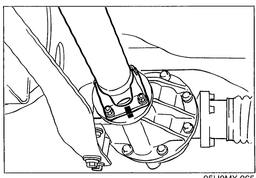 Close-up photo of the propeller shaft companion flange at the differential, with mark/alignment area visible on the flanges before removal.
