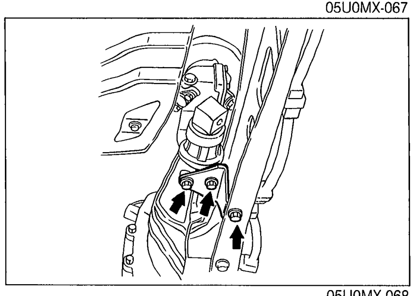 Photo showing the power plant frame bracket with arrows indicating the bolt locations to be removed.