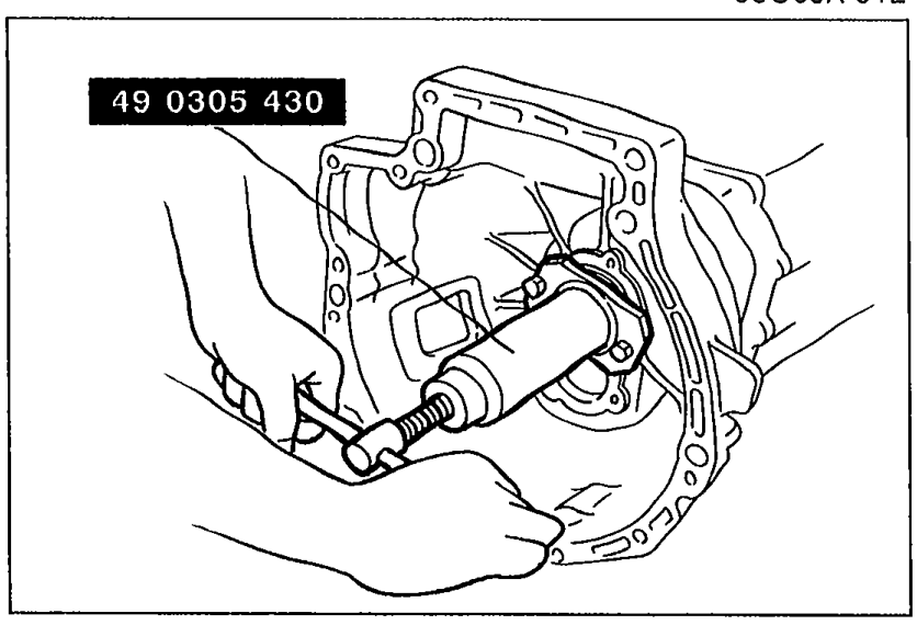 Photo of SST 49 0305 430 (Pusher, main drive shaft) installed on the intermediate housing area to push the transmission case off the intermediate housing and gear assembly.