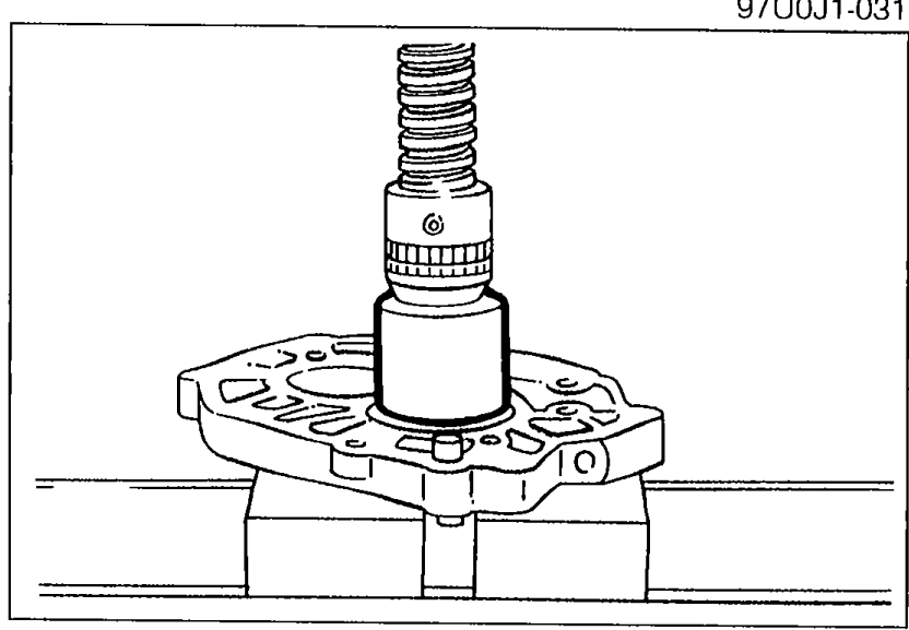 Photograph showing the mainshaft front bearing being pressed out of the bearing housing using a suitable pipe as a driver.