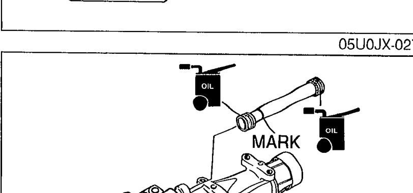 Rod cover installation showing the rod cover being placed onto the transmission case with MARK arrow indicating proper forward orientation.