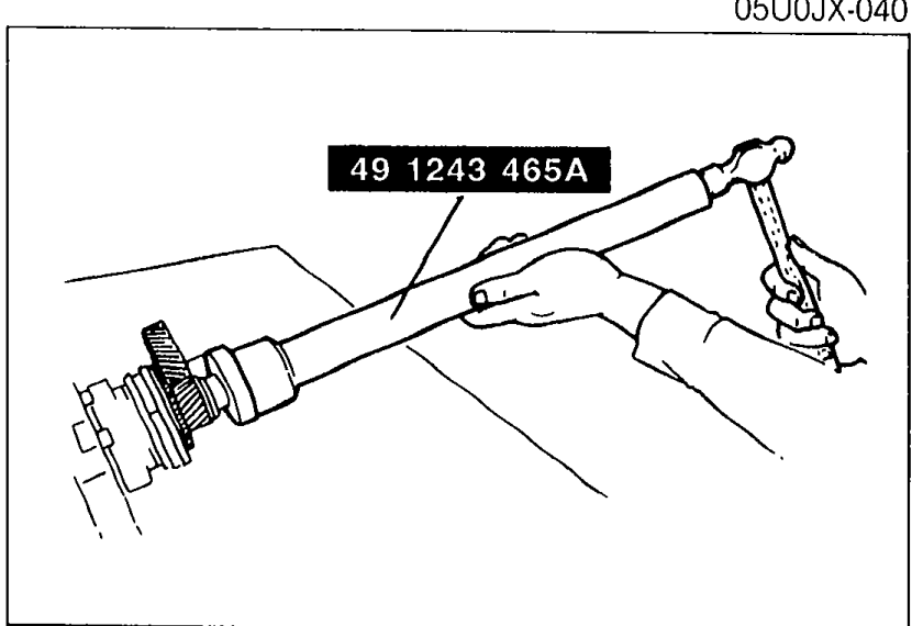 SST (part 49 1243 465A) being used to drive the mainshaft rear bearing onto the mainshaft. Shows the slide-hammer-style installer tool engaged with the bearing.