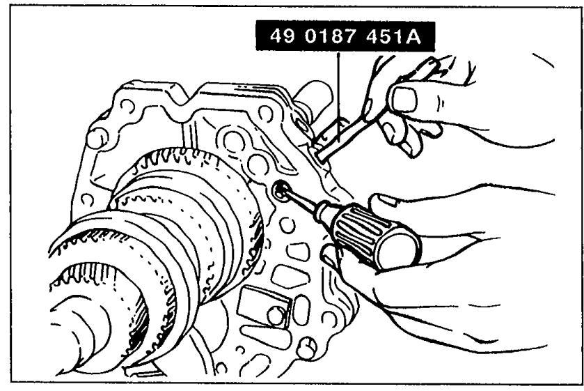 Hand using SST 49 0187 451A with a screwdriver to press the spring and ball (5th/Reverse) into the bearing housing to install the shift rod. Tool number 49 0187 451A is labeled.