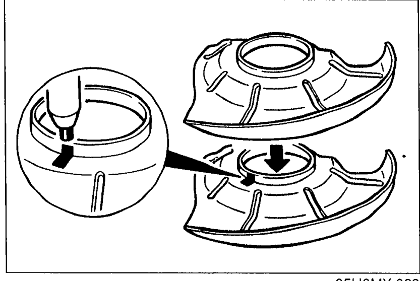 Illustration of the new dust cover showing the punch mark being transferred from the removed dust cover to the new one. An arrow indicates the mark position.