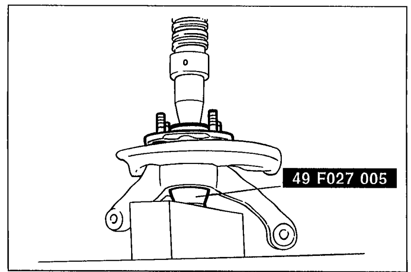 Photograph showing the rear wheel hub assembly being pressed in to the knuckle using SST '49 F027 005'.